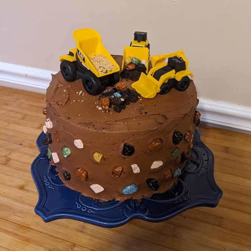 Chocolate construction cake with toy trucks