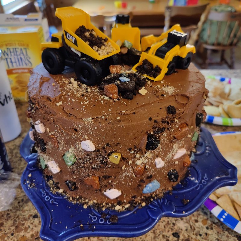Chocolate construction cake with toy trucks, another angle